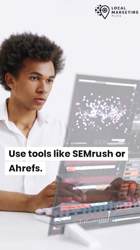 Young man using SEMrush or Ahrefs for keyword research at computer